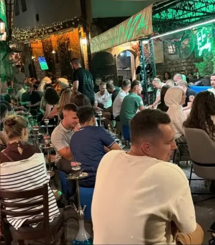 Friends sharing a hookah on the terrace