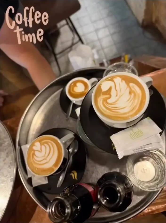 Latte art coffees served on a copper tray