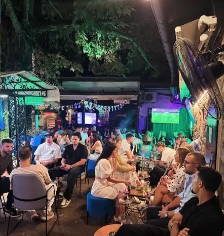 Blue sofas and shisha on the tree-shaded terrace