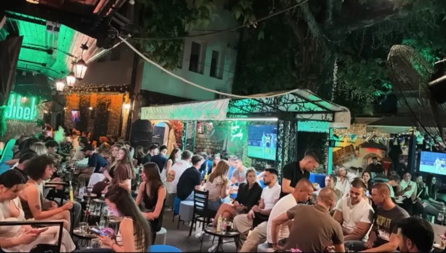Guests socializing under the green canopy