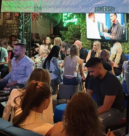 Guests watching the match under the awning